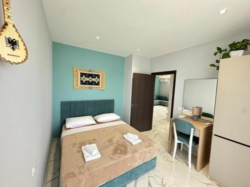 ein kleines Schlafzimmer mit einem Bett und einem Schreibtisch in der Unterkunft TreA Accomodations - Despacito Deluxe Sea View in Vlorë