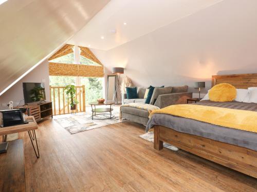 a bedroom with a bed and a couch at Strawberry Fields Annex in Wisbech