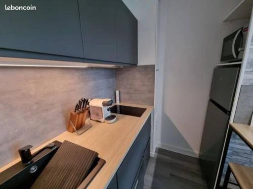 Il comprend une cuisine équipée d'un comptoir et d'un grille-pain. dans l'établissement Escapade en bord de mer : studio à la plage !, à Courseulles-sur-Mer