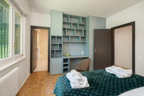 a bedroom with a bed with towels on it at Park Villa Geneva - Swiss Hotel Apartments in Geneva