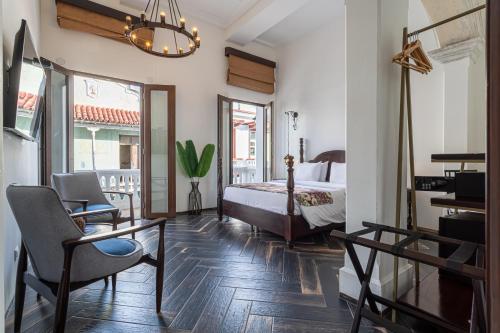 a bedroom with a bed and a desk and a chair at Soy Local Insignia in Cartagena de Indias