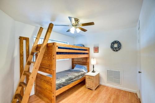 a bedroom with a bunk bed and a ceiling fan at Ormond Beach Home: Walk to Community Beach! in Ormond Beach
