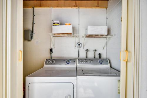 a kitchen with a stove and a washing machine at Ormond Beach Home: Walk to Community Beach! in Ormond Beach
