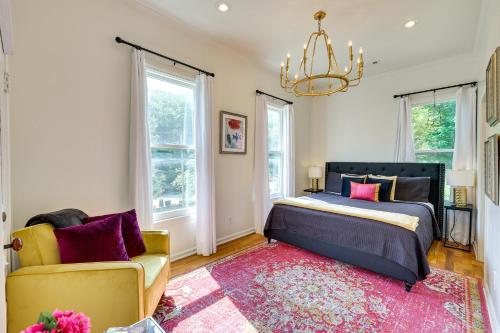 a bedroom with a bed and a couch and a chandelier at Eureka Springs Vacation Rental Less Than 1 Mi to Downtown in Eureka Springs