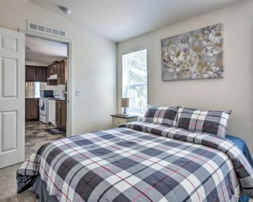 a bedroom with a bed with a plaid blanket at Blue Mountainview in Mariposa