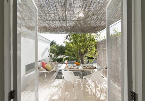 a dining room with a table and chairs on a patio at Masseria Alchimia in Fasano