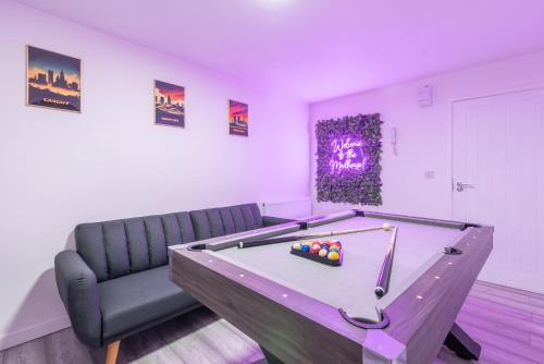 uma sala de jogos com uma mesa de bilhar e uma cadeira em Exquisite Cardiff Apartments- with Garden Lounge & Games Room em Cardiff
