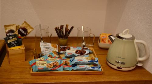 a table with a tea kettle and bags of food at Monterosso Rooms in Monterosso al Mare