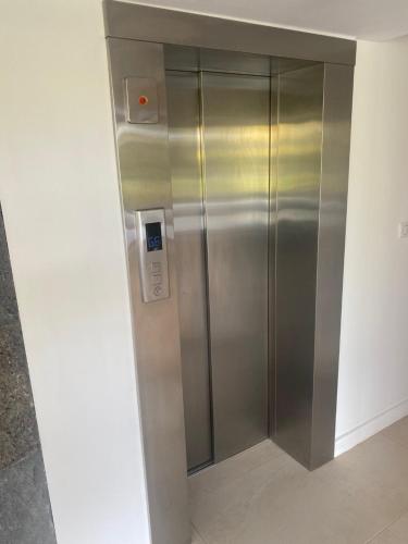 an elevator in a building with a silver door at Villa Shanti Anahita in Grande Rivière Sud Est