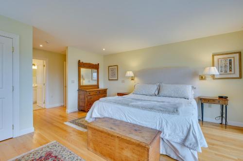 a bedroom with a large bed and a wooden table at Luxury Vacation Rental in the Berkshires! in Williamstown