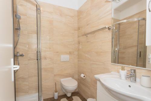 a bathroom with a shower and a toilet and a sink at Mara in Šibenik