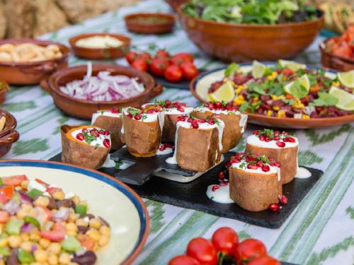 a table topped with appetizers and plates of food at Fincahotel Treurer - Olive Grove & Grand House - Adults Only in Algaida