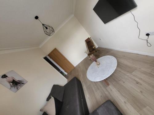 an overhead view of a living room with a couch and a table at Beautiful 2-bed flat in the heart of Hendon in The Hyde