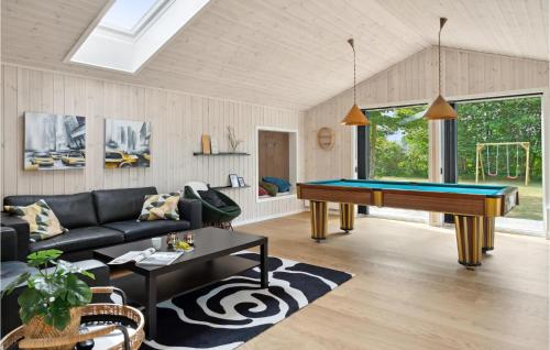 a living room with a pool table in it at 5 Bedroom Amazing Home In Glesborg in Glesborg