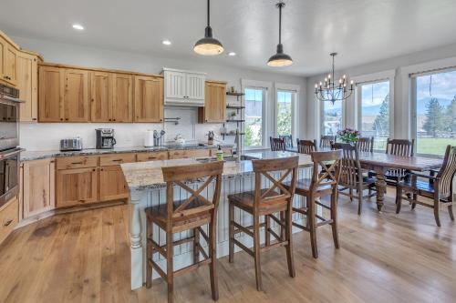 a kitchen with wooden cabinets and a table with chairs at Three Bears Get Away farmhouse in Hamilton