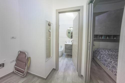 a small bedroom with a bed and a bathroom at Sun&Garden Flat in Cagliari