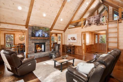 Una sala de estar con muebles de cuero y chimenea. en Hooch Holler Hideaway, en Morganton