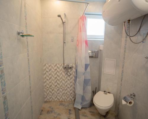 a bathroom with a shower and a toilet at Aleks Holiday-center,sea,parking in Burgas City