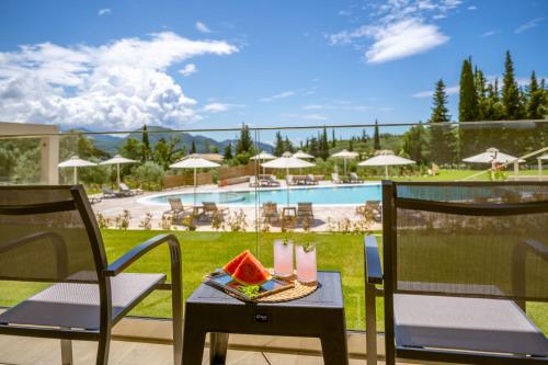 a patio with a table and chairs and a pool at EPHYRA in Sivota