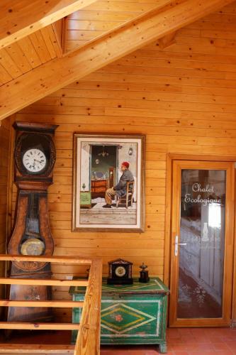 a man sitting in a chair in a room with a clock at Dar Zaghouan in Zaghouan