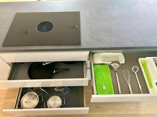 a kitchen counter with a drawer with utensils at Seeparkvilla – Wohlfühlen am See und im Grünen in Bregenz