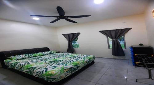 a bedroom with a bed and a ceiling fan at Hostel KLIA in Sepang