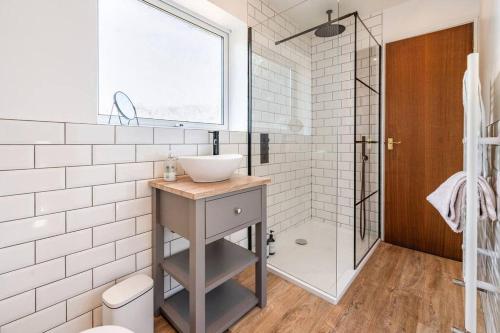 a bathroom with a sink and a shower at Cosy, Conveniently Located House by Dwell Haven - Close to Cardiff centre in Cardiff