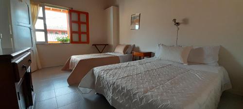 una camera d'albergo con due letti e una finestra di Hotel Dorado Jardín a Jardin