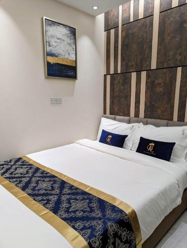 a bedroom with a large bed with a wooden headboard at Hotel Royal Bengal in Dhaka