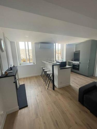 a large room with a kitchen and a living room at appartement 2 neuf climatisée in Blaye