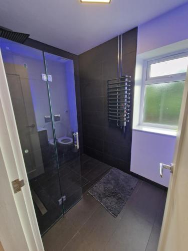 a bathroom with a glass shower and a toilet at Stunning 3 bed house sleeps6 in Nottingham