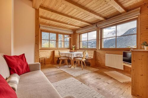 a living room with a couch and a table at Zyprianhof in Nova Levante
