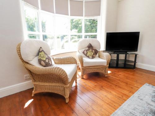 two chairs and a television in a living room at Homewood in Preston