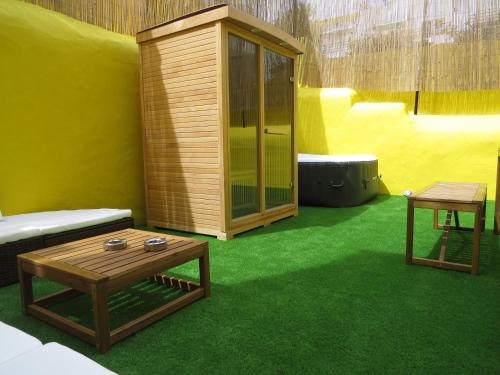 a room with a couch and a table and green carpet at The Macarena Beach Hostel in Lagos