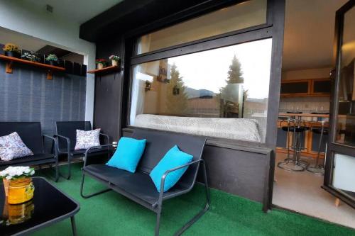 a room with blue chairs and a large window at Super appartement Cocooning vu Mont Blanc in Sallanches