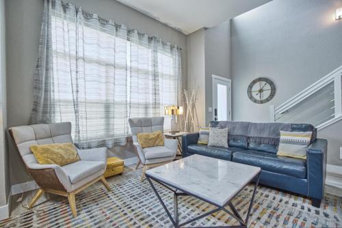 a living room with a couch and chairs and a table at Modern Townhome near Old Town, Breweries, & River! in Fort Collins