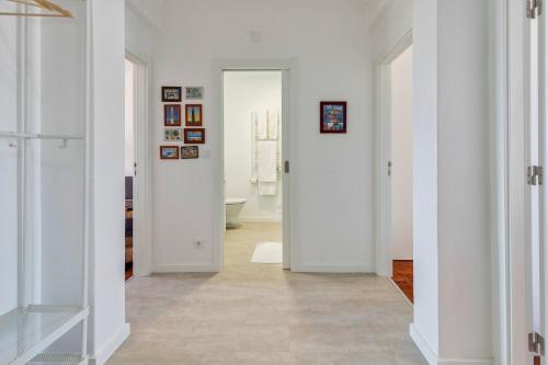 a hallway with white walls and white doors at Castle View in Setúbal