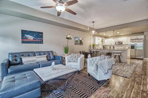 a living room with a couch and chairs and a kitchen at 2 Bedroom townhome, super close to downtown FC! in Fort Collins