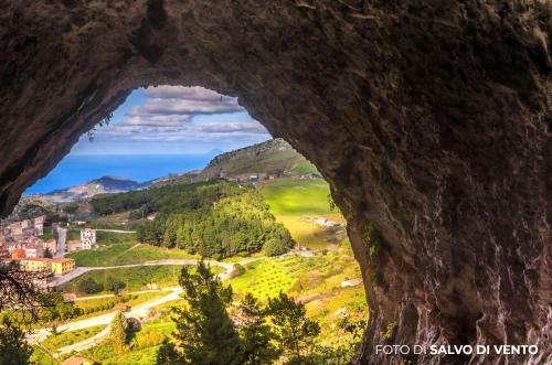 a view through a hole in the side of a mountain at Gratteri Holiday Appartamento Vista Mari in Gratteri