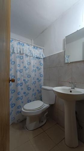 a bathroom with a toilet and a sink at 2 Hotel Saleh in Angeles