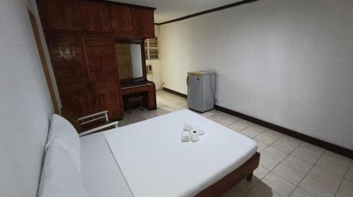 a room with a white table and a refrigerator at 2 Hotel Saleh in Angeles