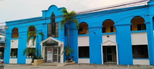 a blue and white building with a church at 2 Hotel Saleh in Angeles