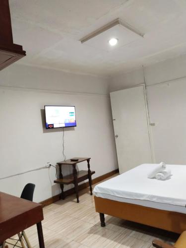 a room with a bed and a tv on the wall at 2 Hotel Saleh in Angeles