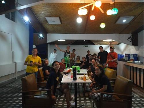 a group of people sitting at a table in a restaurant at 2 Hotel Saleh in Angeles