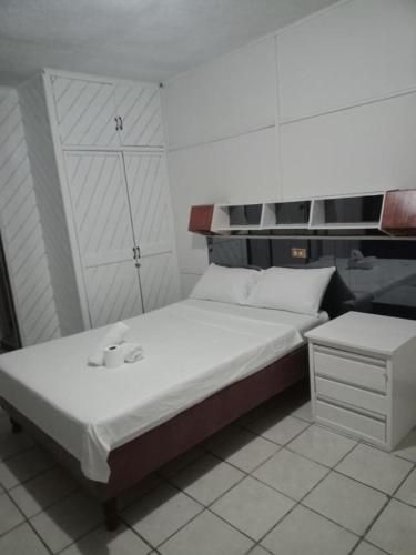 a small bedroom with a bed and a night stand at 2 Hotel Saleh in Angeles