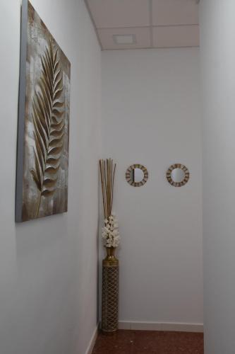 a vase of flowers in a room with two pictures on the wall at SIERRA LAGO in Córdoba