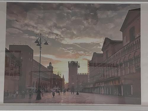 a painting of a city street with people walking at Dodo's House in Ferrara