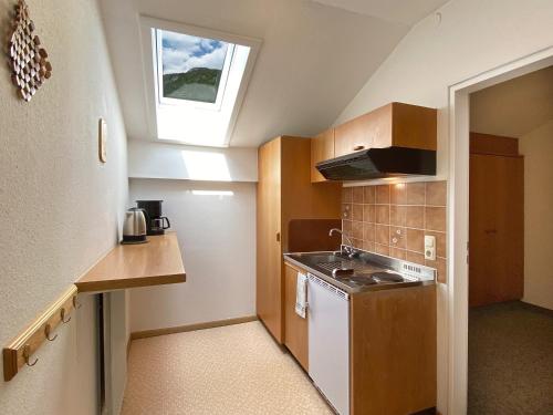 a small kitchen with a stove and a window at Appartement-Hotel Happy Kienberg in Pfronten