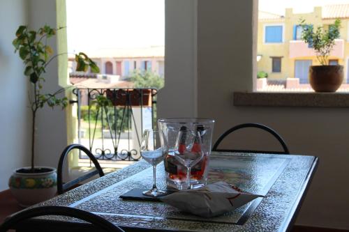 a table with two glasses and a napkin on it at Appartamento Le Vele in Porto San Paolo