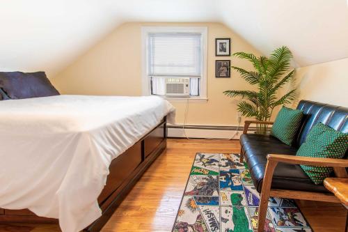 a bedroom with a bed and a couch at Pet-Friendly Cranston Home with Fire Pit and BBQ! in Cranston